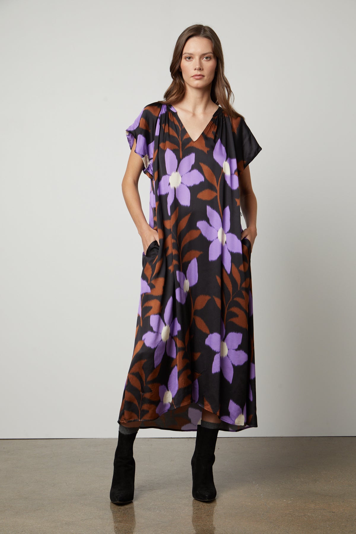A woman wearing a Velvet by Graham & Spencer FRANCINE PRINTED MIDI DRESS.-26914797093057