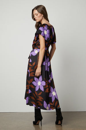 The model is wearing a Velvet by Graham & Spencer FRANCINE PRINTED MIDI DRESS.