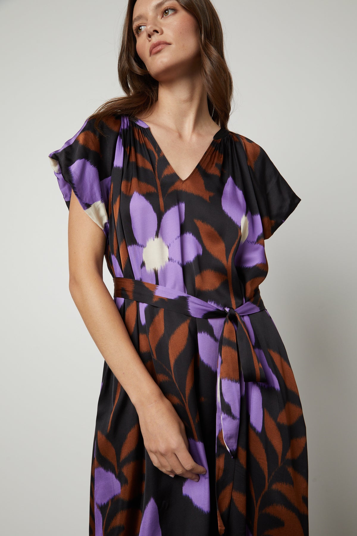 A woman wearing a soft FRANCINE PRINTED MIDI DRESS by Velvet by Graham & Spencer.-26914797125825