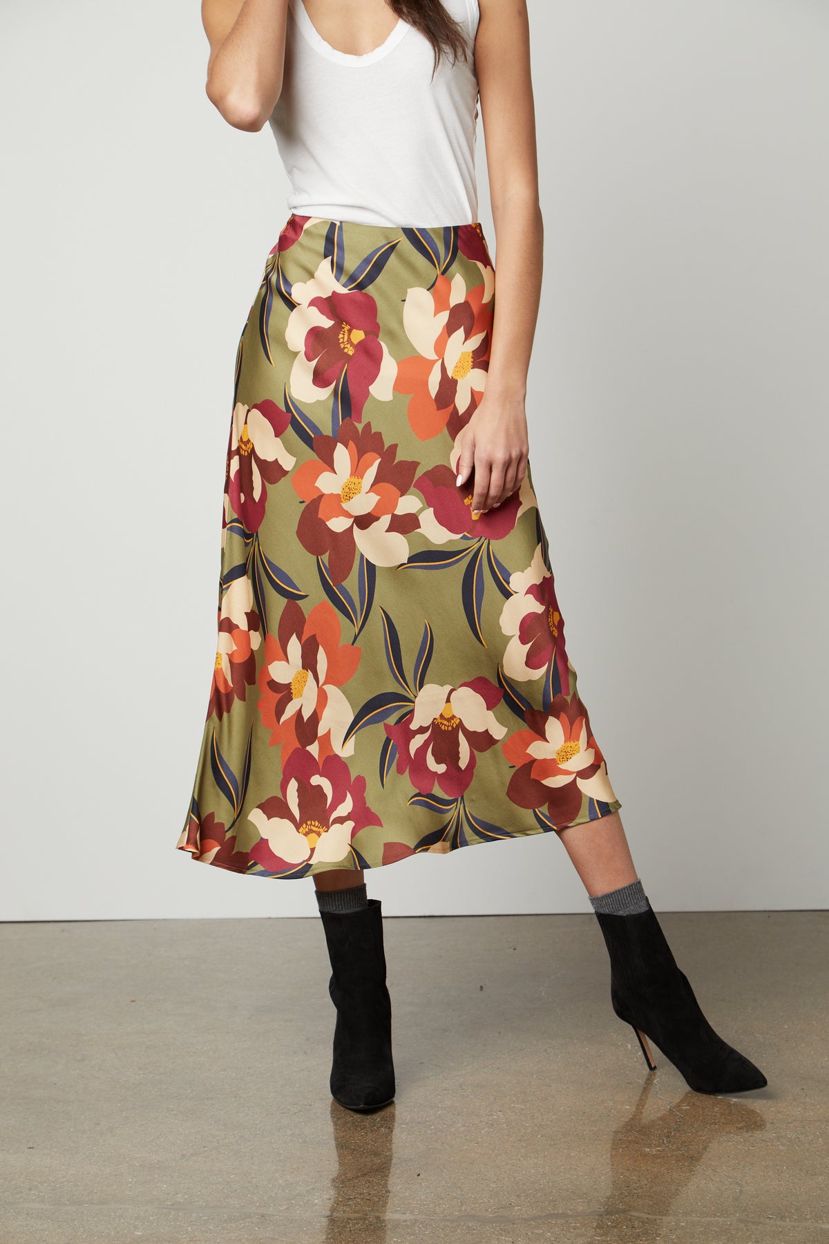 A woman wearing a KAIYA PRINTED SKIRT by Velvet by Graham & Spencer, with an elastic waist.-26914849063105