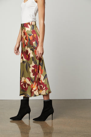 A woman wearing a Kaiya printed skirt with an elastic waist from Velvet by Graham & Spencer.