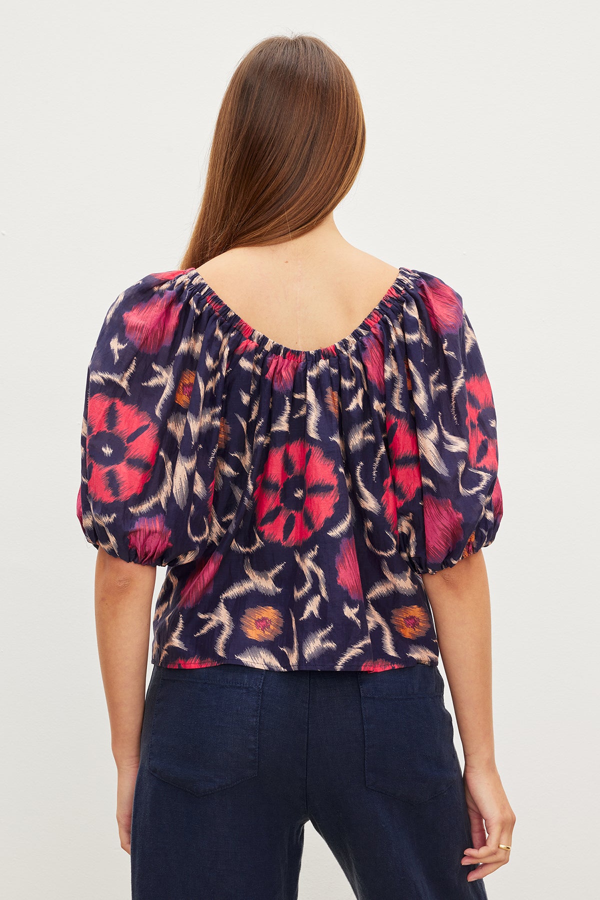 The back view of a woman wearing an EDLIN PRINTED SILK COTTON VOILE TOP by Velvet by Graham & Spencer.-35982322073793
