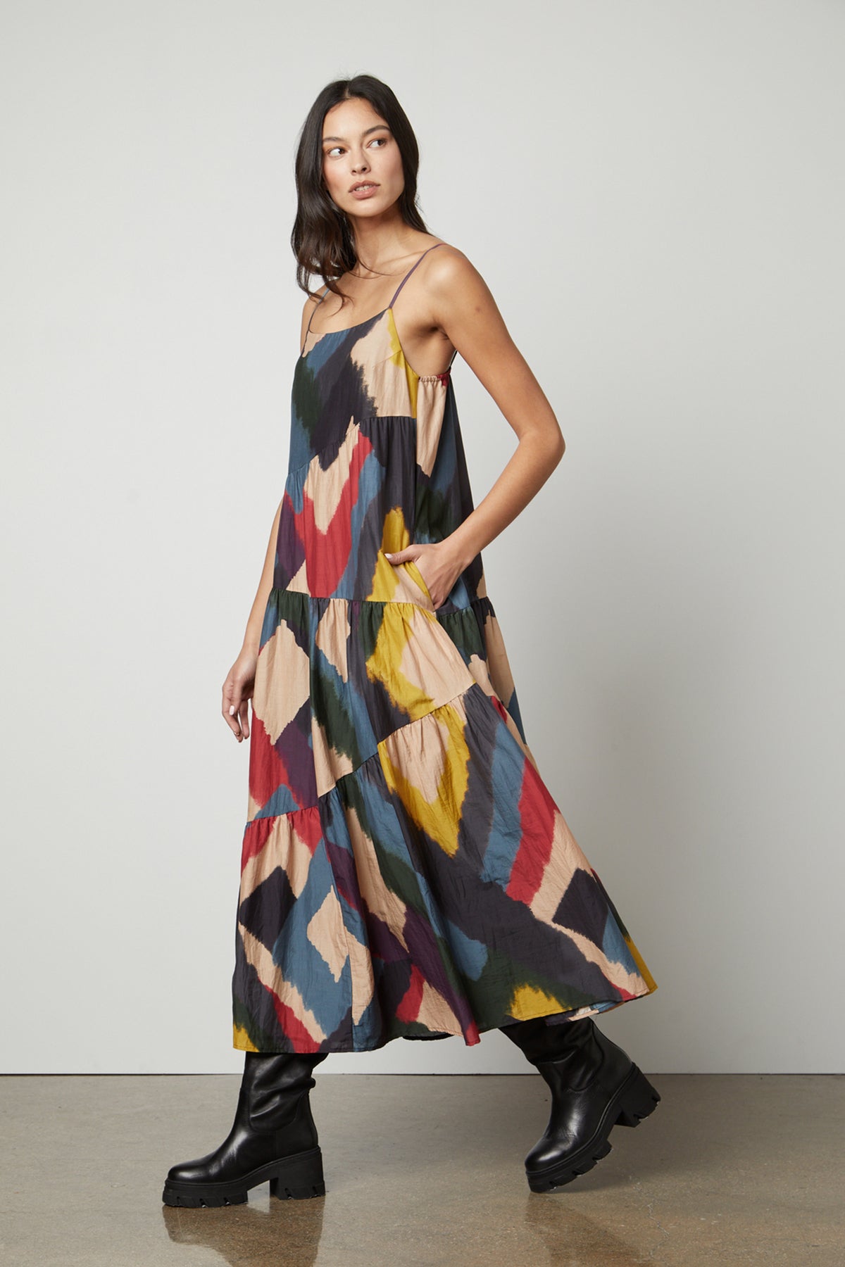 A woman wearing a MARYANN PRINTED MAXI DRESS by Velvet by Graham & Spencer and black boots.-26861400359105