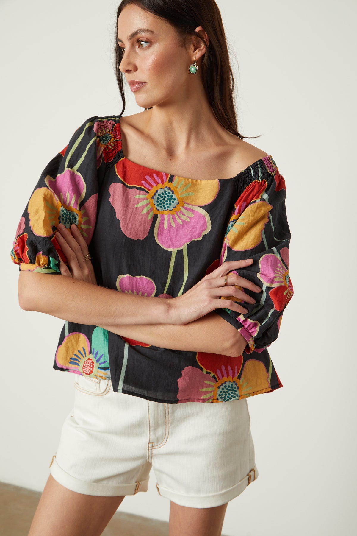   Jasmine Top in bold floral with black background and white denim shorts front close up woman arms folded in front 