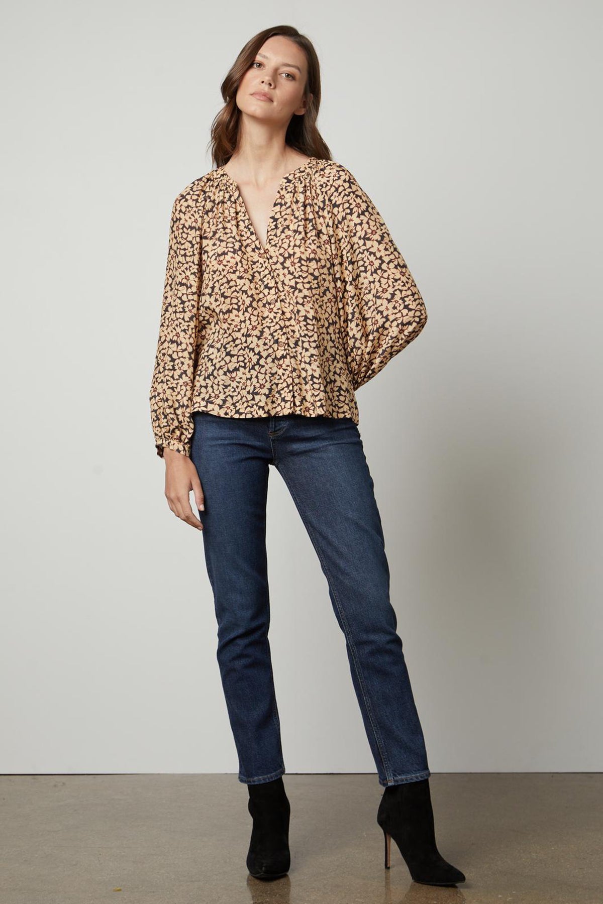 The model is wearing a Velvet by Graham & Spencer MELINDA PRINTED BUTTON-UP TOP.-26895474327745