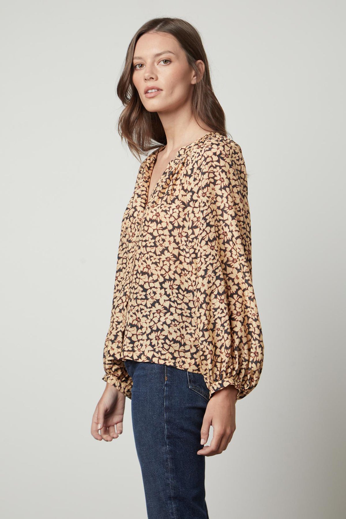   A woman wearing a Velvet by Graham & Spencer MELINDA PRINTED BUTTON-UP TOP blouse. 