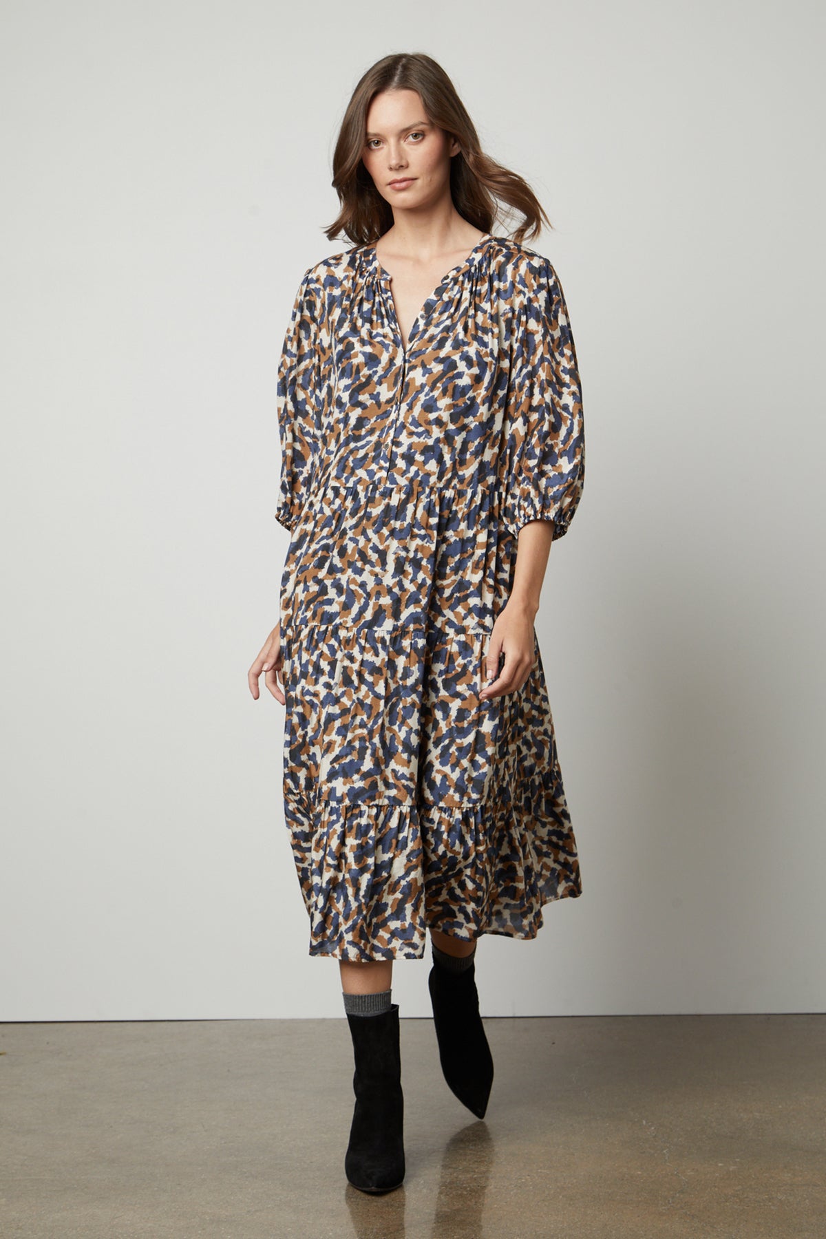 The model is wearing a Velvet by Graham & Spencer OTTILIE PRINTED BOHO DRESS.-26914793652417