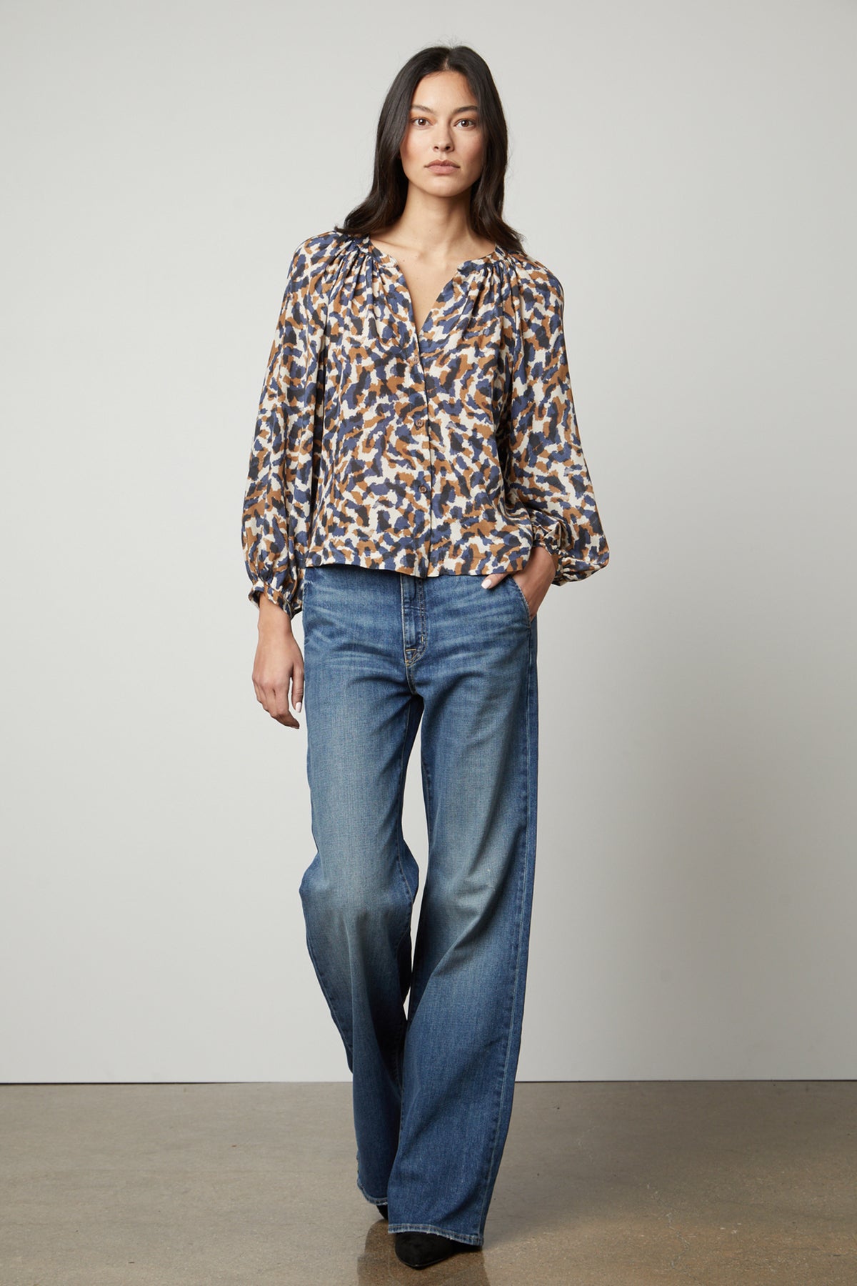The model is wearing a Graham & Spencer Melinda Printed Button-Up Top.-26895474524353