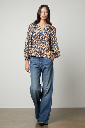 The model is wearing a Graham & Spencer Melinda Printed Button-Up Top.