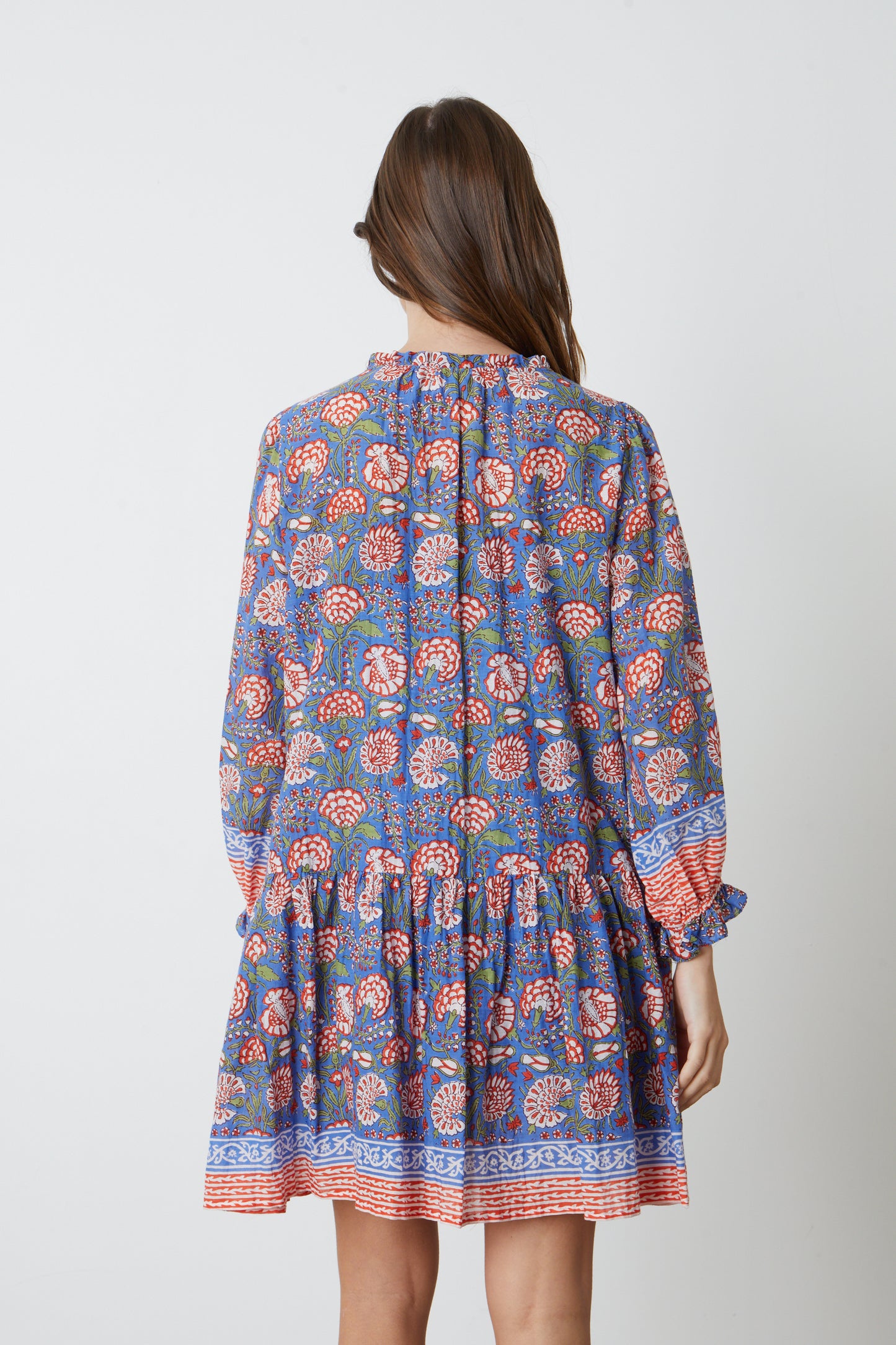 The back view of a woman wearing a Velvet by Graham & Spencer JULIETTE PRINTED BOHO DRESS.-26577349968065