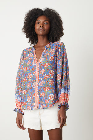 The model is wearing a Velvet by Graham & Spencer MARCELLA PRINTED BOHO TOP.