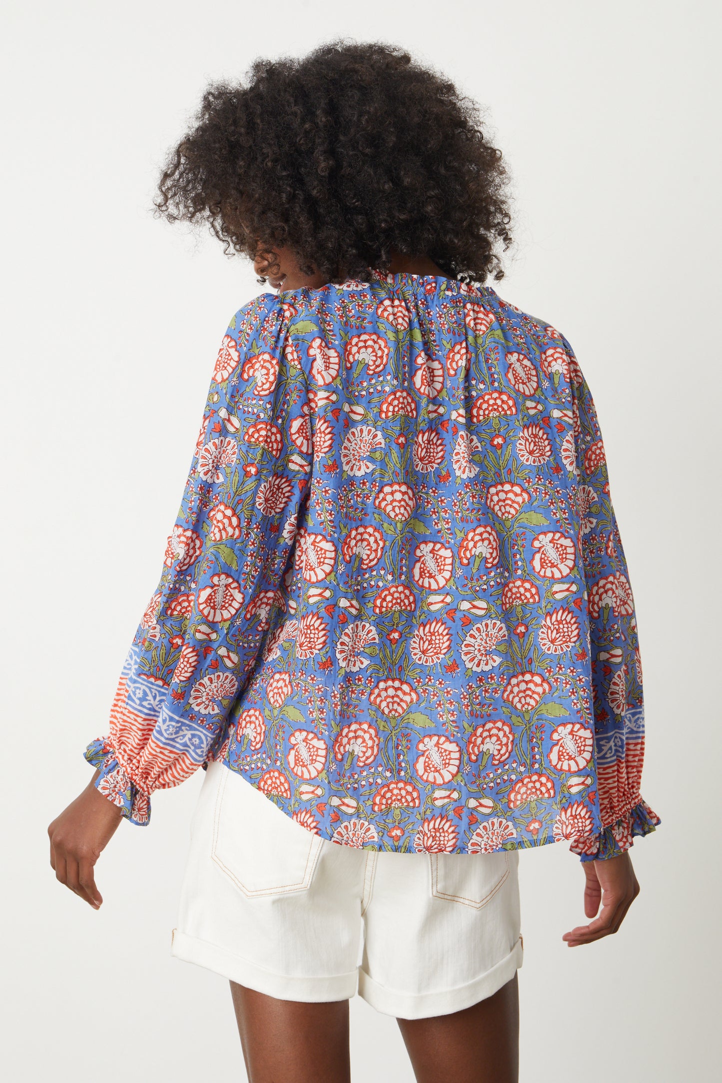 The back view of a woman wearing a Velvet by Graham & Spencer MARCELLA PRINTED BOHO TOP.-26577341874369
