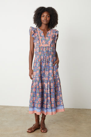 a woman wearing a blue and pink Velvet by Graham & Spencer ROSALIA PRINTED DRESS.