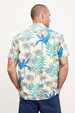 A man wearing the Velvet by Graham & Spencer Iggy Button-Up Shirt standing with his back to the camera, looking to his right side, against a white background.