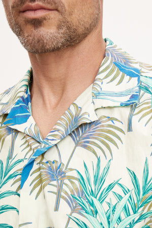 Close-up of a man wearing a casual Velvet by Graham & Spencer Iggy button-up shirt, focusing on the collar and pattern detail.