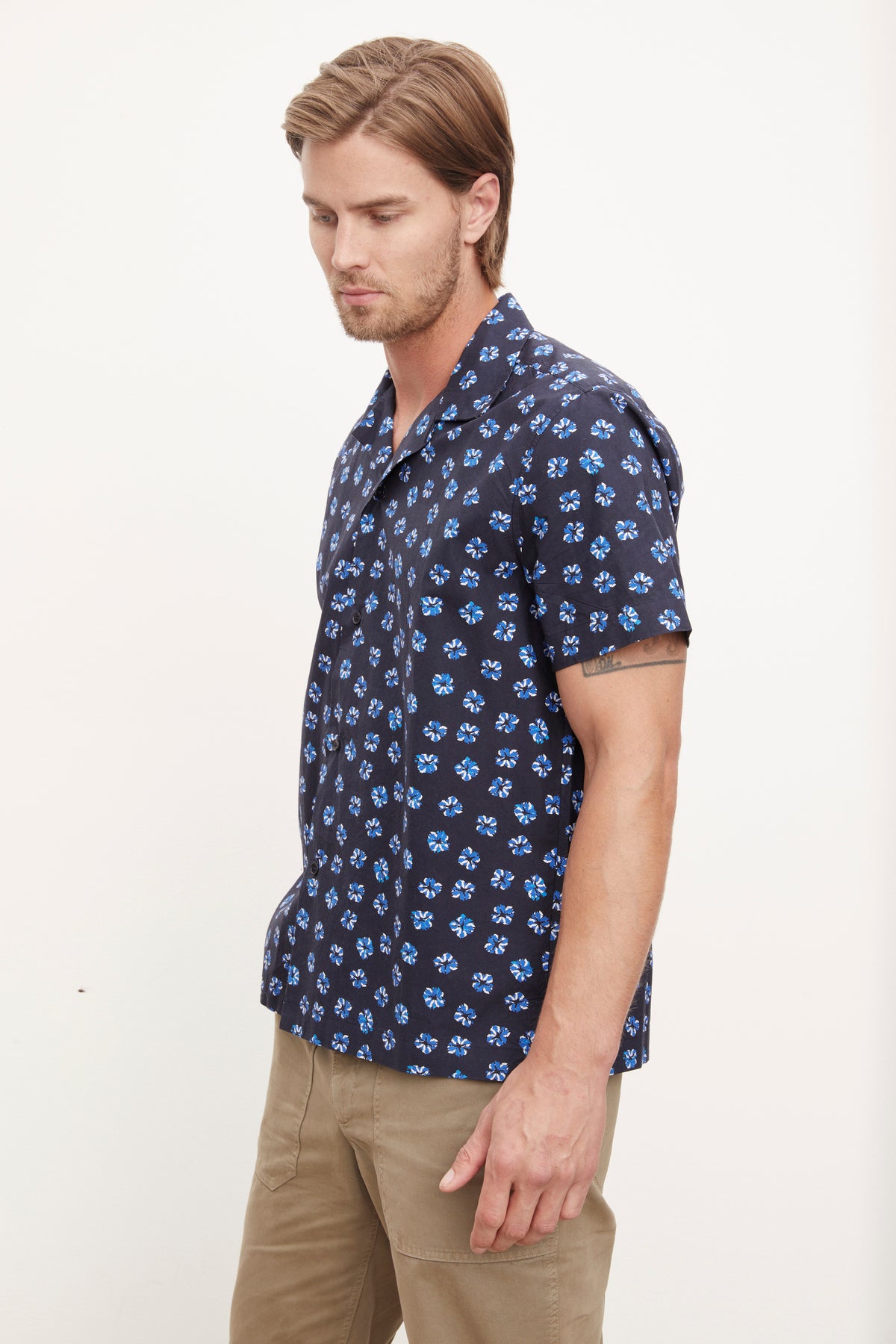   Man wearing a patterned Iggy button-up shirt from Velvet by Graham & Spencer with a relaxed fit and khaki pants. 