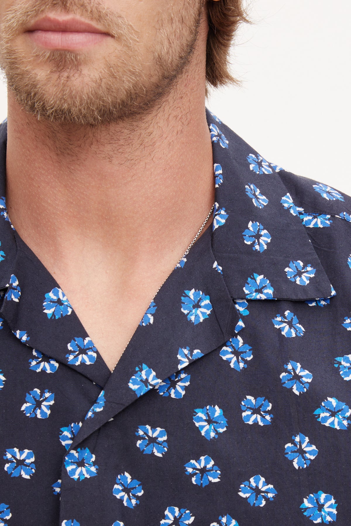   Close-up of a man wearing a Velvet by Graham & Spencer Iggy Button-Up Shirt. 