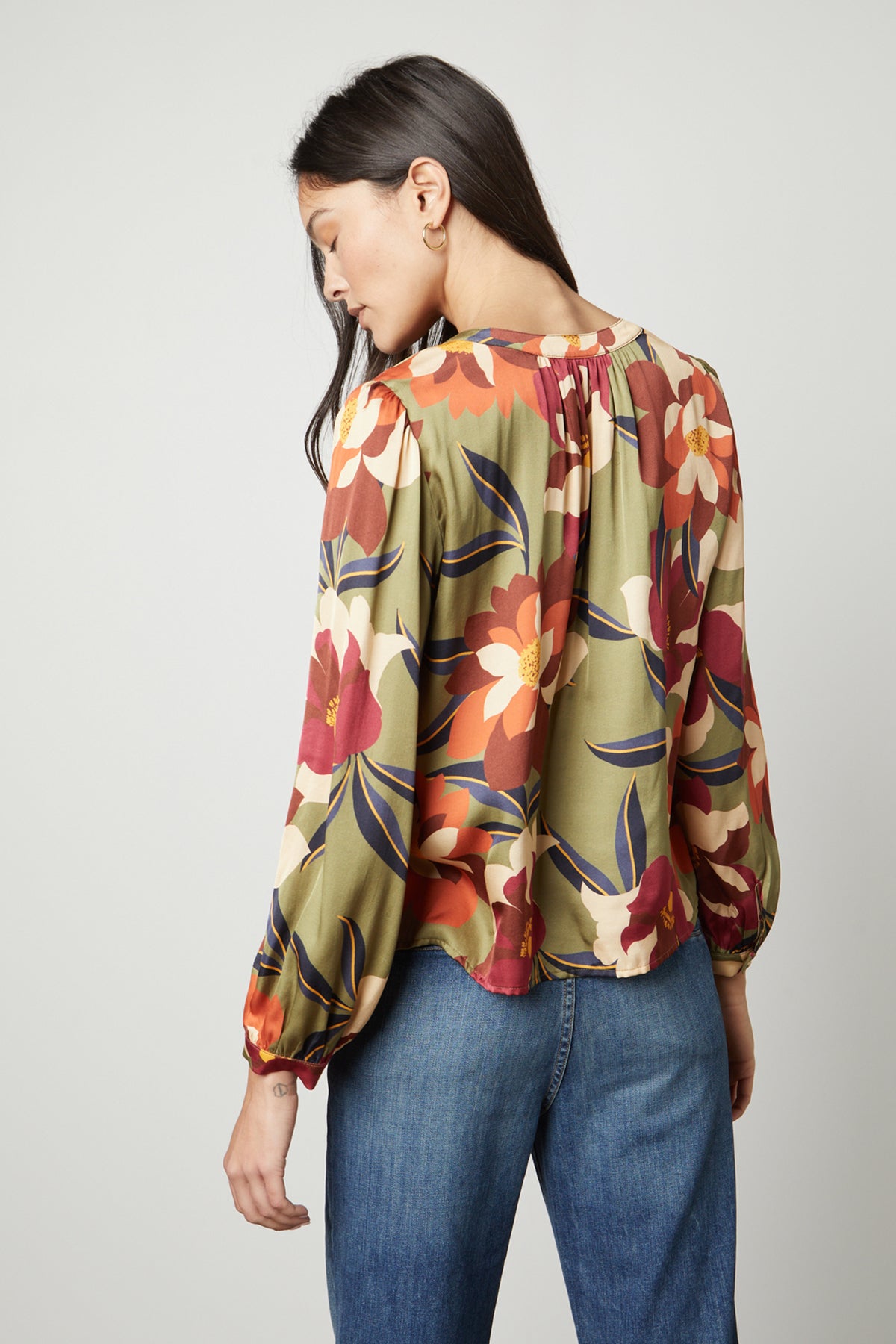 The back view of a woman wearing a Velvet by Graham & Spencer timeless look ISRA PRINTED V-NECK BLOUSE.-26914817835201