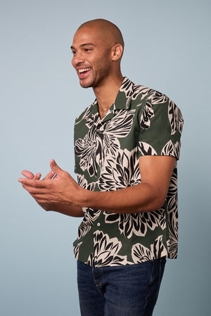 A man wearing a Velvet by Graham & Spencer Iggy Printed Button-Up Shirt.