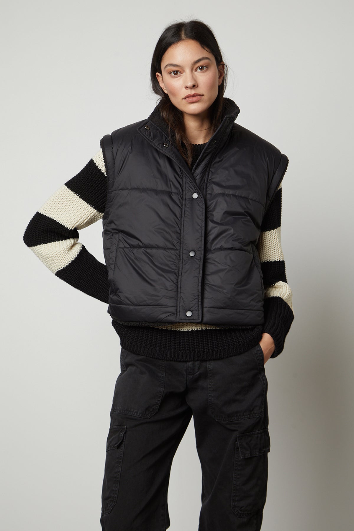 The model is wearing a ALICIA REVERSIBLE PUFFER SHERPA VEST by Velvet by Graham & Spencer.-35649874886849
