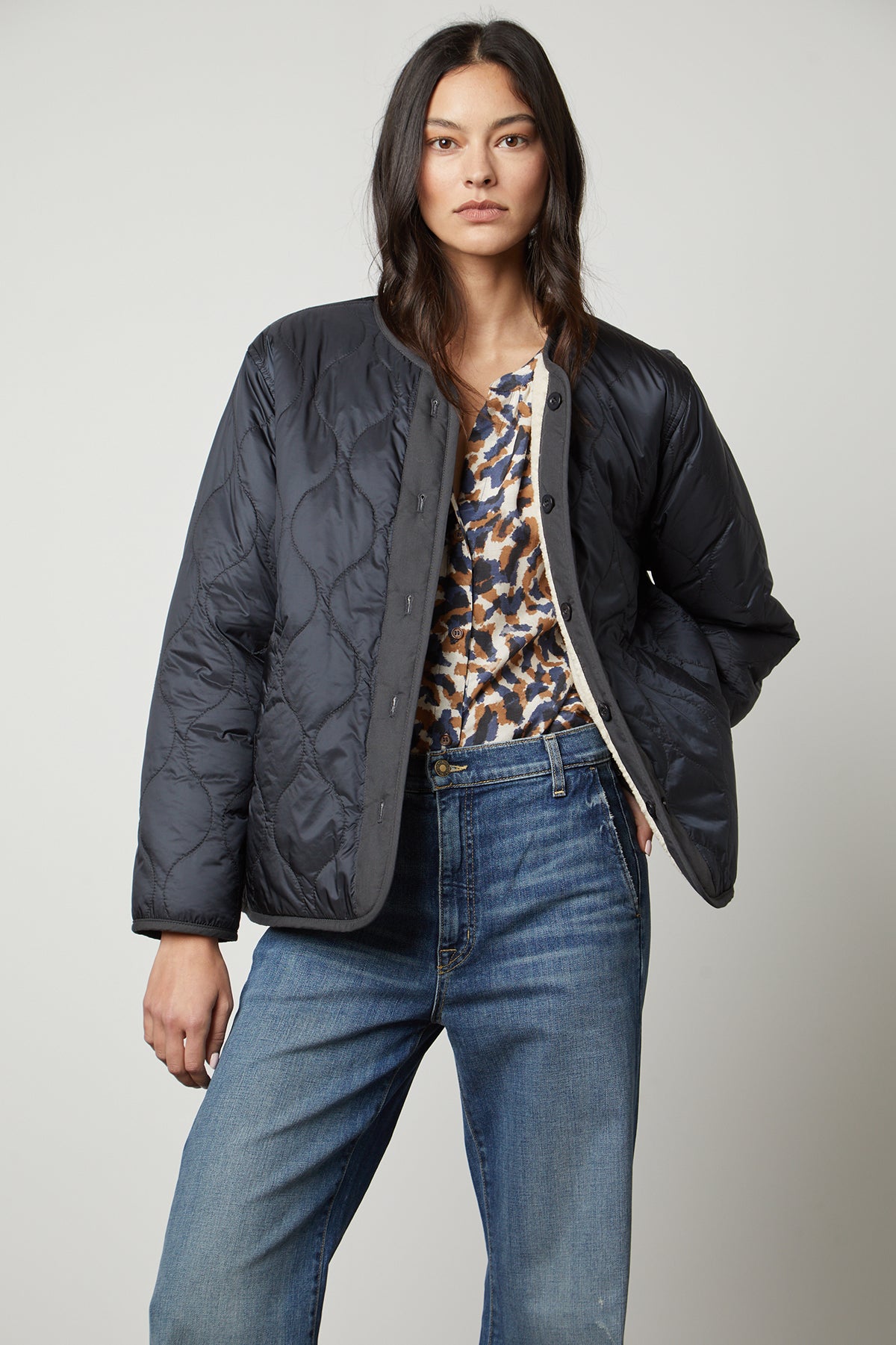 A utilitarian model wearing a Velvet by Graham & Spencer Marissa Reversible Quilted Sherpa Jacket.-35507745915073