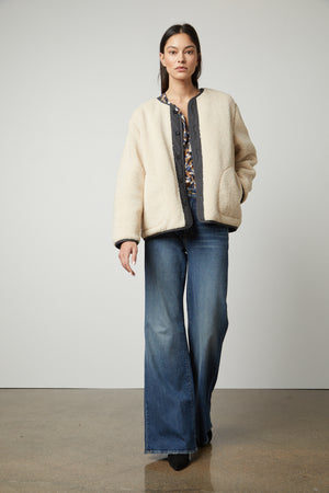 The model is wearing a Velvet by Graham & Spencer Marissa Reversible Quilted Sherpa Jacket.