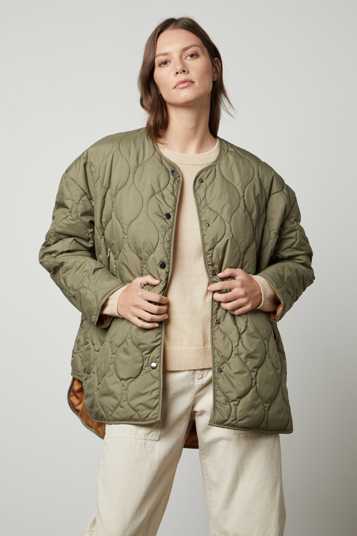 A woman wearing a PAITYN QUILTED JACKET by Velvet by Graham & Spencer.-35655942668481