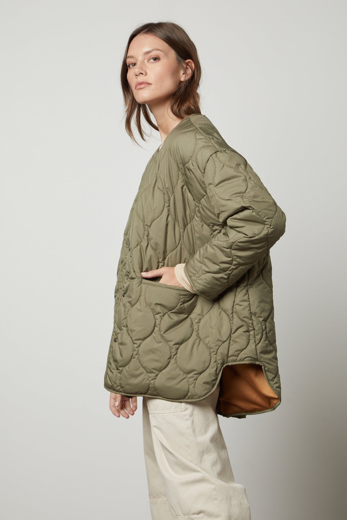   A woman wearing a PAITYN QUILTED JACKET by Velvet by Graham & Spencer. 