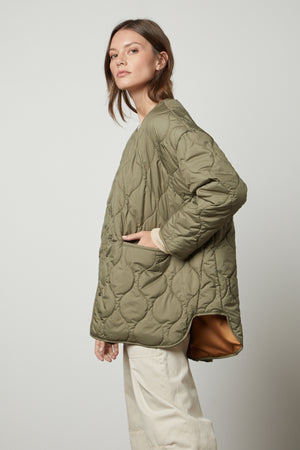 A woman wearing a PAITYN QUILTED JACKET by Velvet by Graham & Spencer.