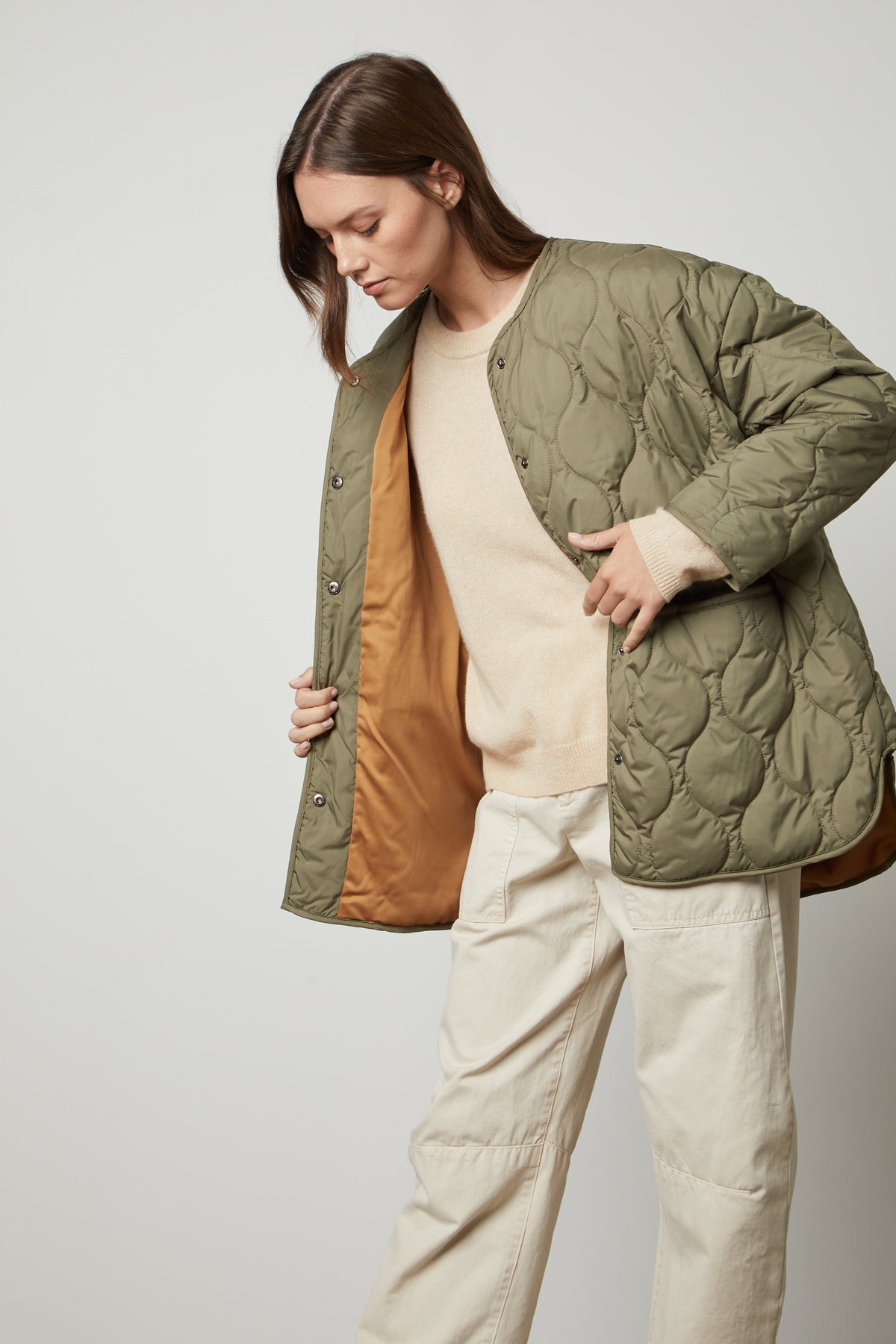 A woman wearing a green Velvet by Graham & Spencer PAITYN QUILTED JACKET.-35655942701249