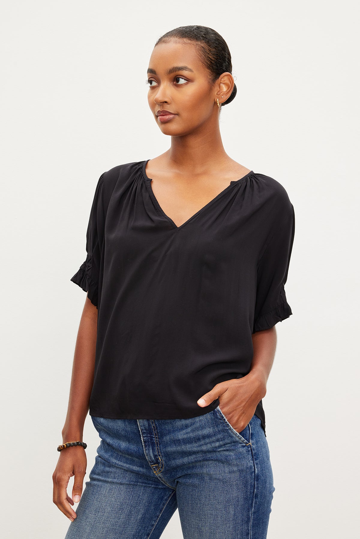   A woman wearing a Velvet by Graham & Spencer CALISSA SPLIT NECK BLOUSE top. 