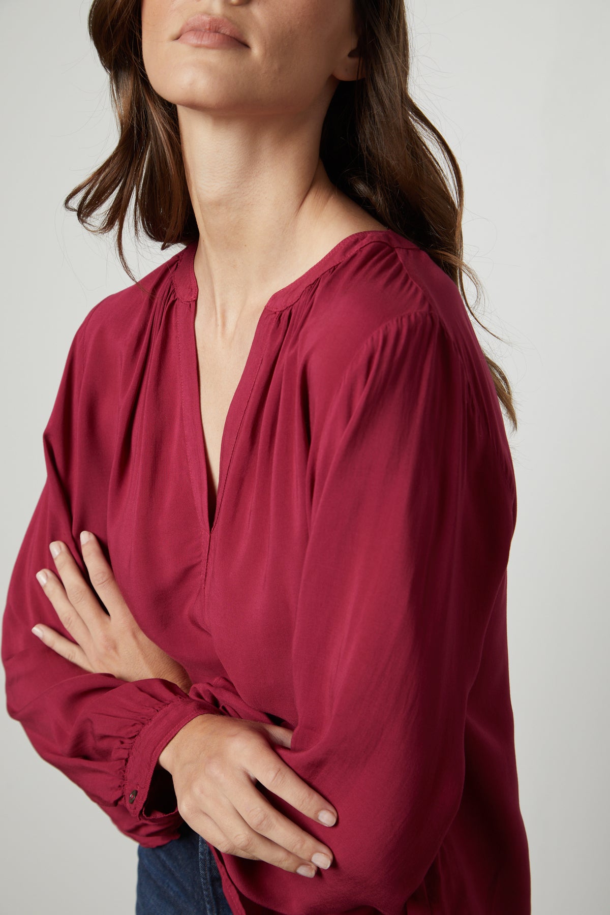 A woman wearing a Velvet by Graham & Spencer Posie Split Neck Blouse and jeans.-26861471236289