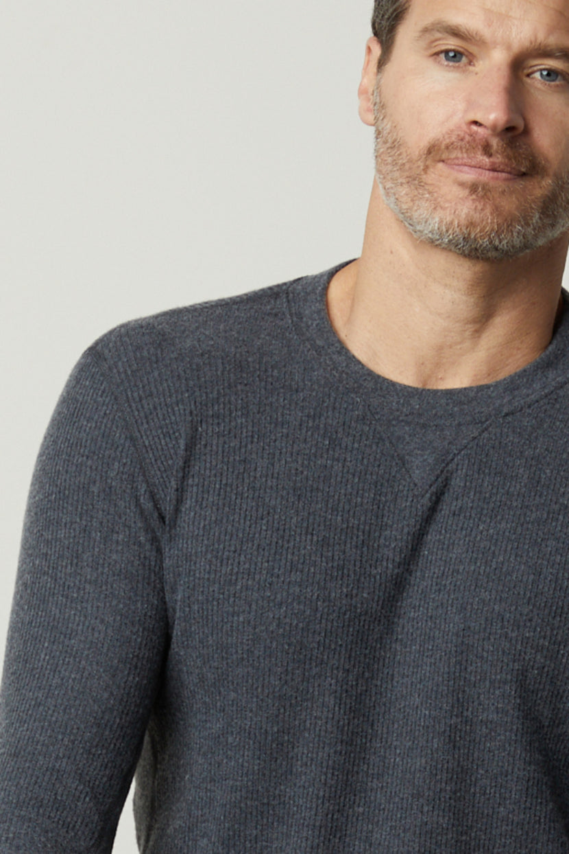 A man in a grey Velvet by Graham & Spencer sweater, the AUGUSTUS RIB KNIT CREW, is posing for a photo.