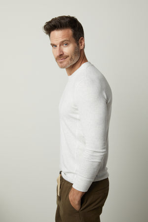 A man wearing an Augustus Rib Knit Crew t-shirt and khaki pants by Velvet by Graham & Spencer.