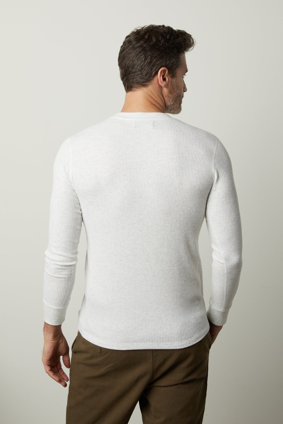 The back view of a man wearing a Velvet by Graham & Spencer AUGUSTUS RIB KNIT CREW white long - sleeved shirt.-26827671404737