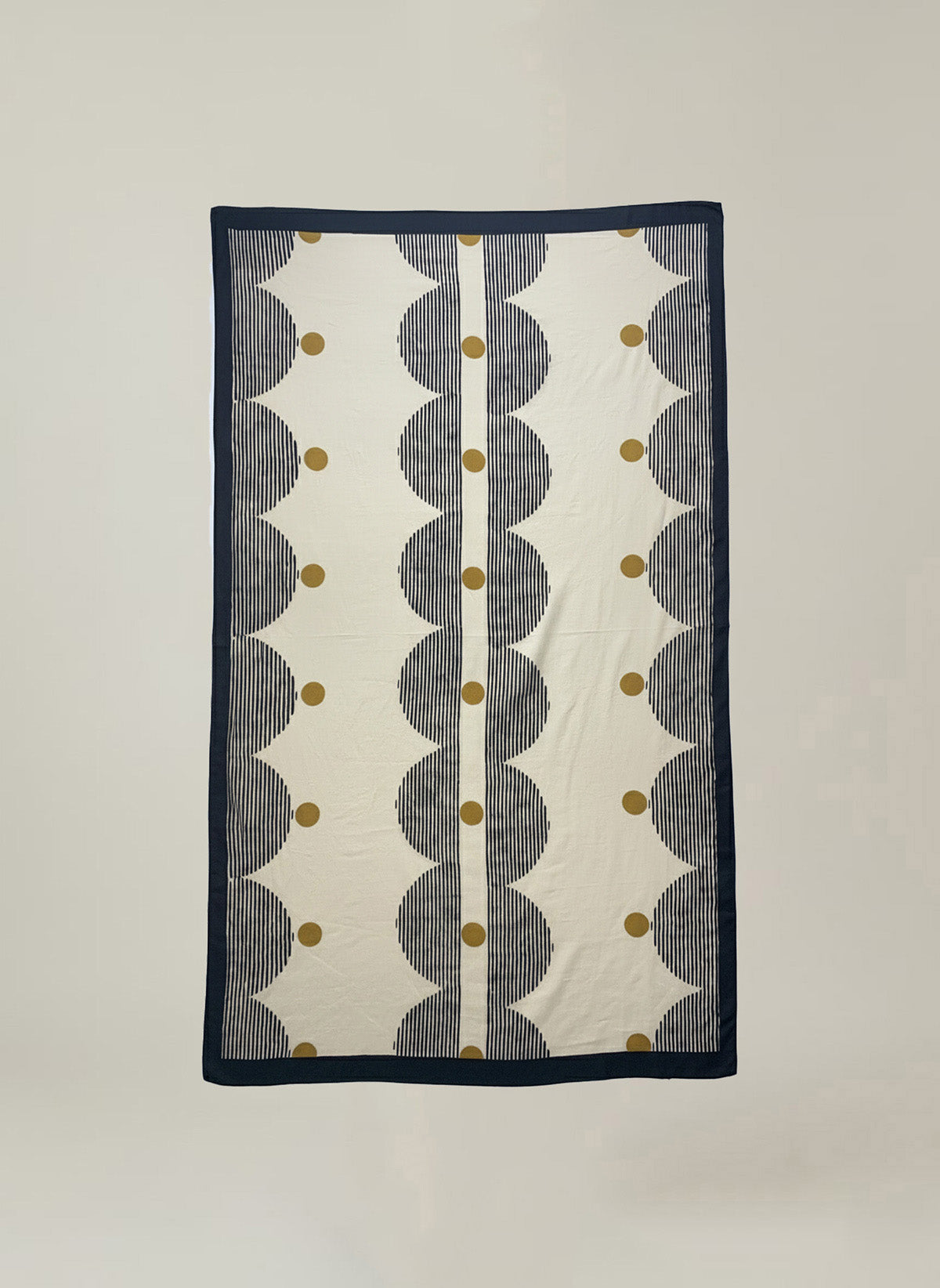 The ROBI SARONG by Velvet by Graham & Spencer features a geometric pattern with black scalloped shapes, vertical lines, and mustard yellow dots on a cream background, finished with a black border.-41384413987009