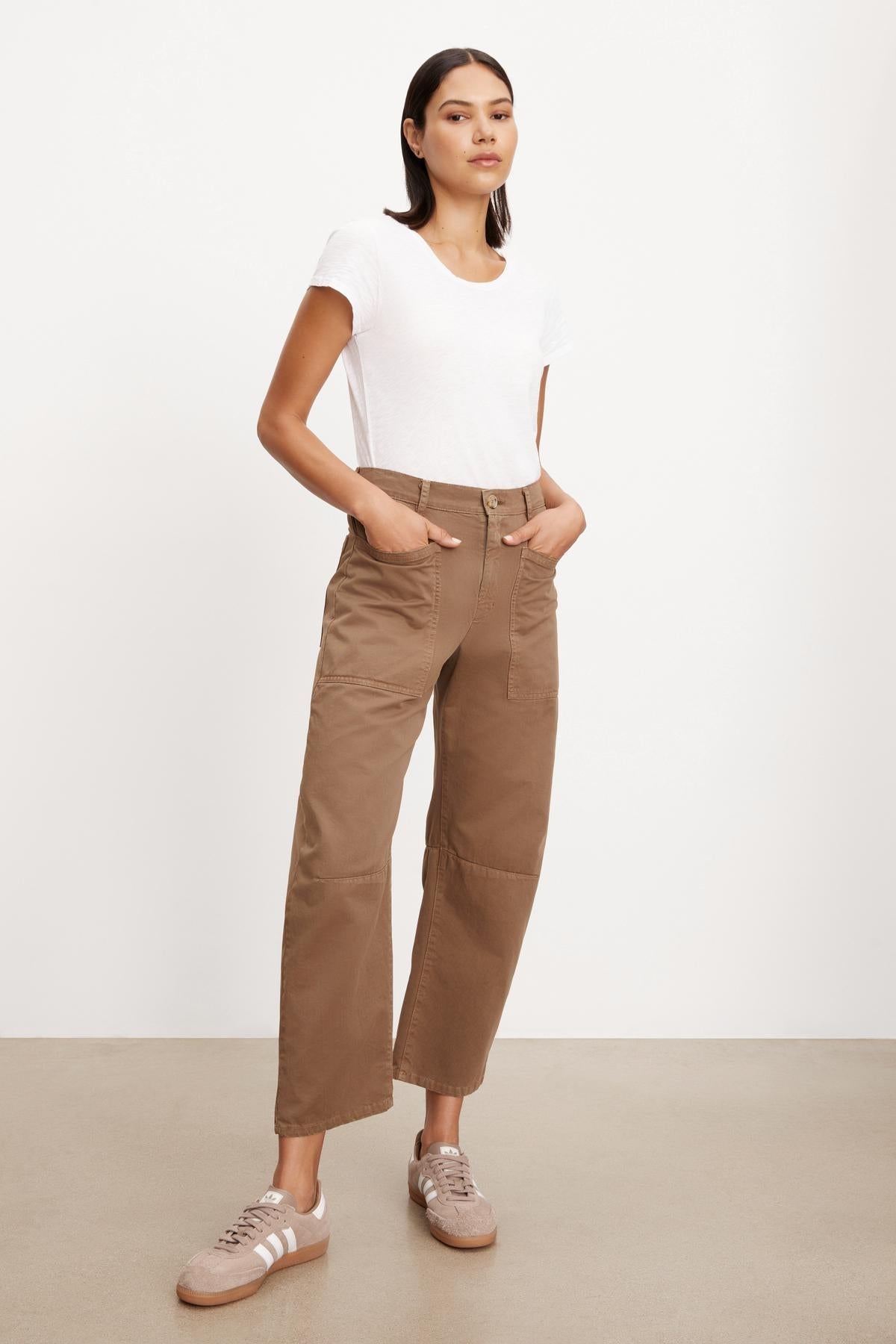The model is wearing a white t-shirt and Velvet by Graham & Spencer brown cropped pants with patch pockets.-36001385382081