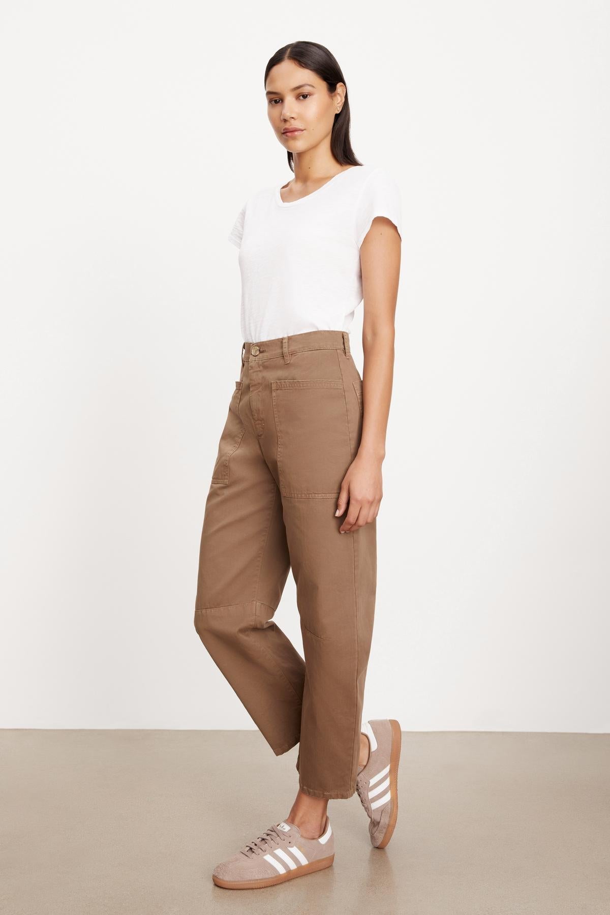   The model is wearing a white t-shirt and Velvet by Graham & Spencer BRYLIE SANDED TWILL UTILITY PANT with patch pockets. 