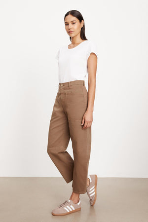 The model is wearing a white t-shirt and Velvet by Graham & Spencer BRYLIE SANDED TWILL UTILITY PANT with patch pockets.