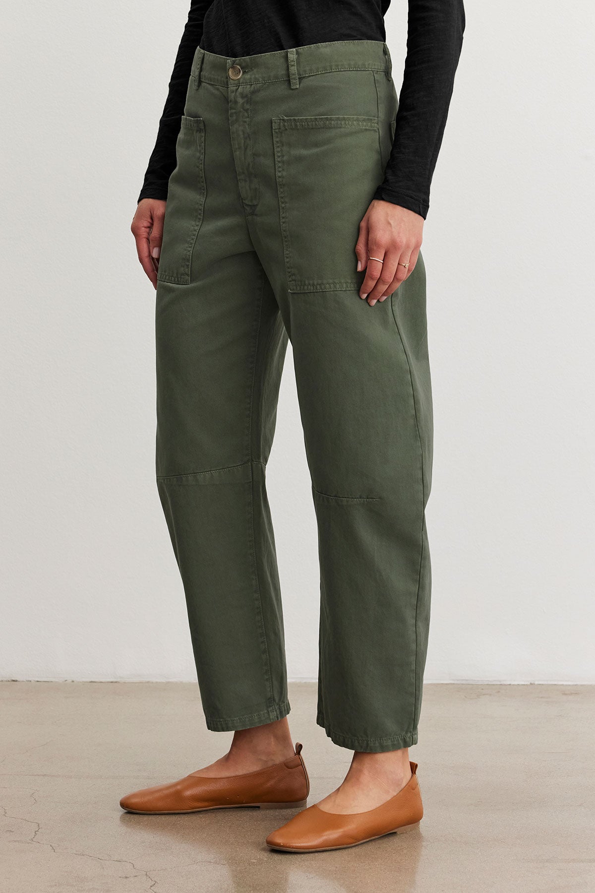 Someone is wearing the Brylie Sanded Twill Utility Pant by Velvet by Graham & Spencer paired with tan ballet flats, creating a chic look.-38670214627521