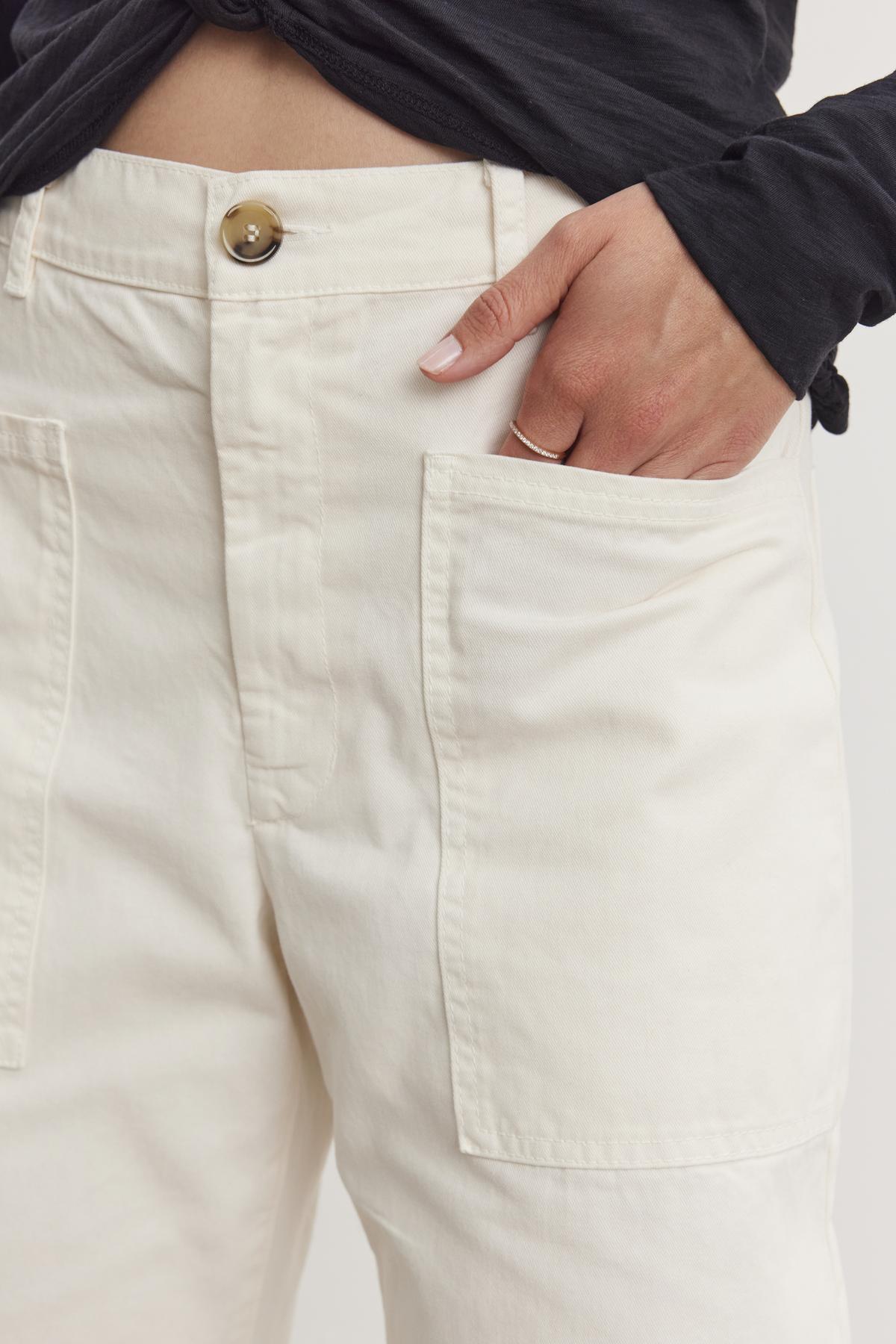 A person casually rests their hand in the pocket of BRYLIE SANDED TWILL UTILITY PANT by Velvet by Graham & Spencer.-38512513876161