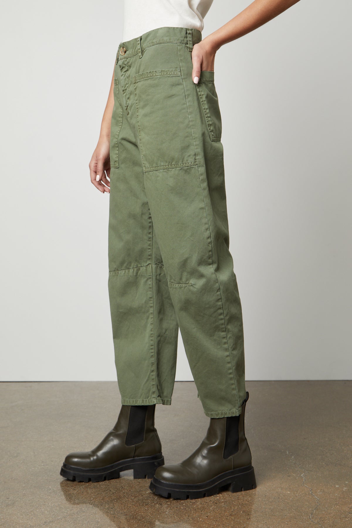 A woman wearing the Velvet by Graham & Spencer BRYLIE SANDED TWILL UTILITY PANT made of cotton twill and featuring patch pockets.-36118556573889