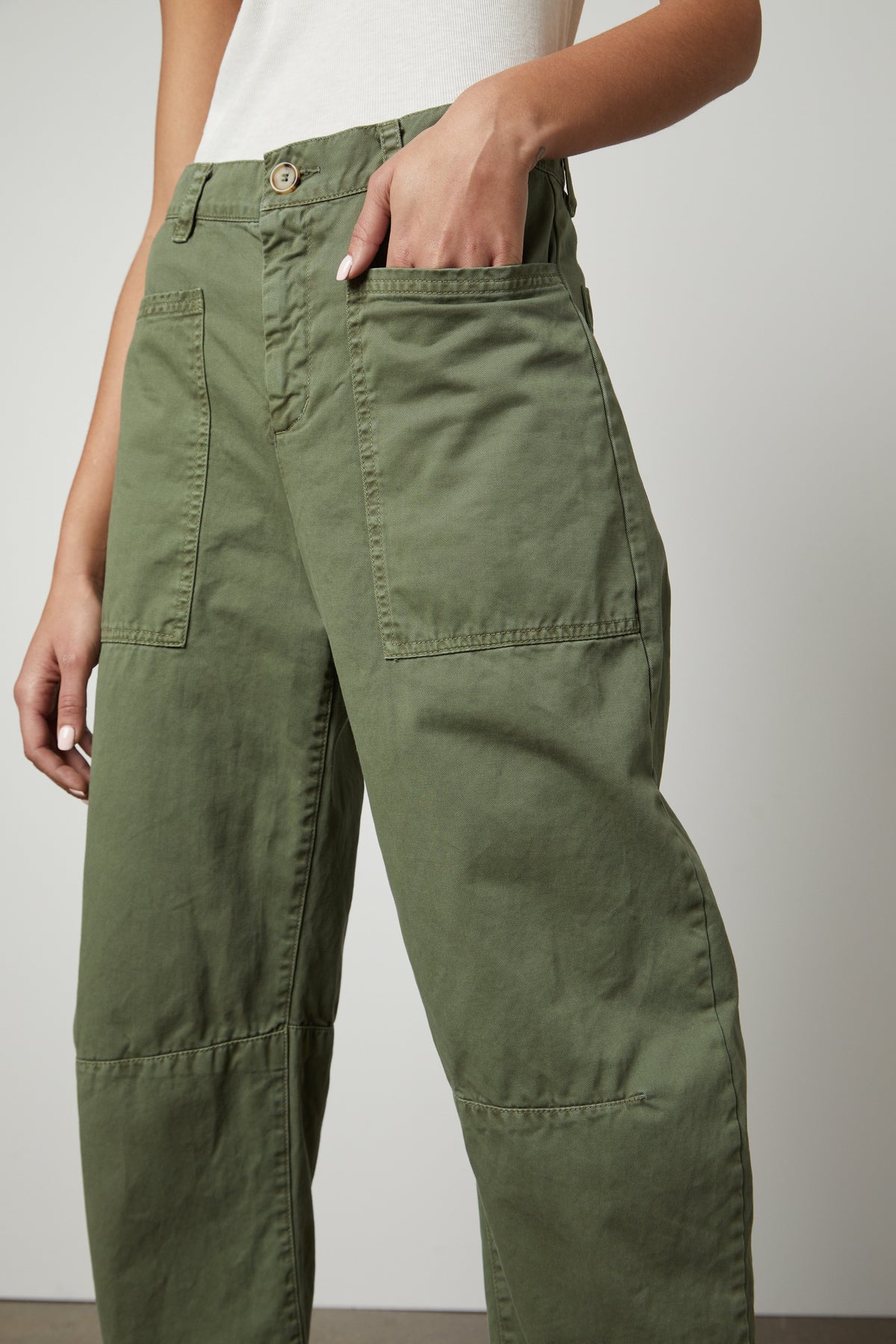   A woman wearing a pair of Velvet by Graham & Spencer BRYLIE SANDED TWILL UTILITY PANT. 
