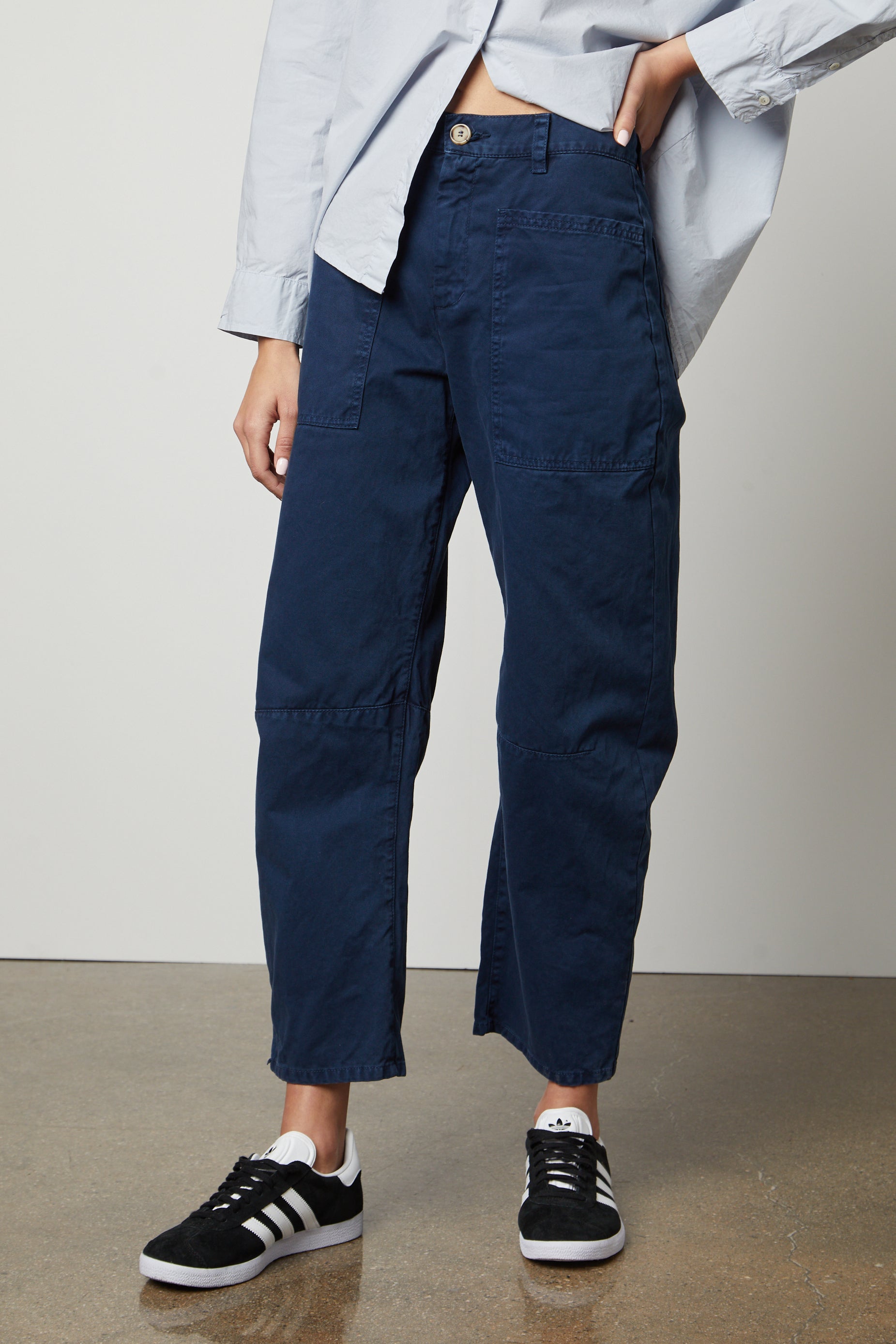   A woman wearing Velvet by Graham & Spencer BRYLIE SANDED TWILL UTILITY PANT and a white shirt. 