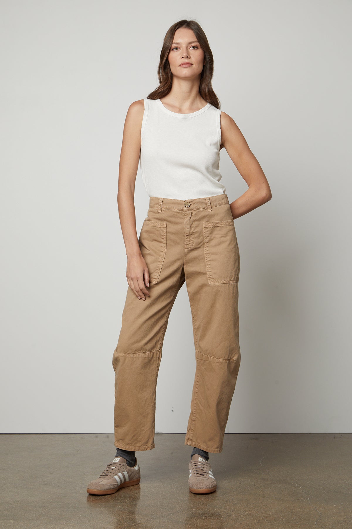   The model is wearing a white top and Velvet by Graham & Spencer's BRYLIE SANDED TWILL UTILITY PANT. 