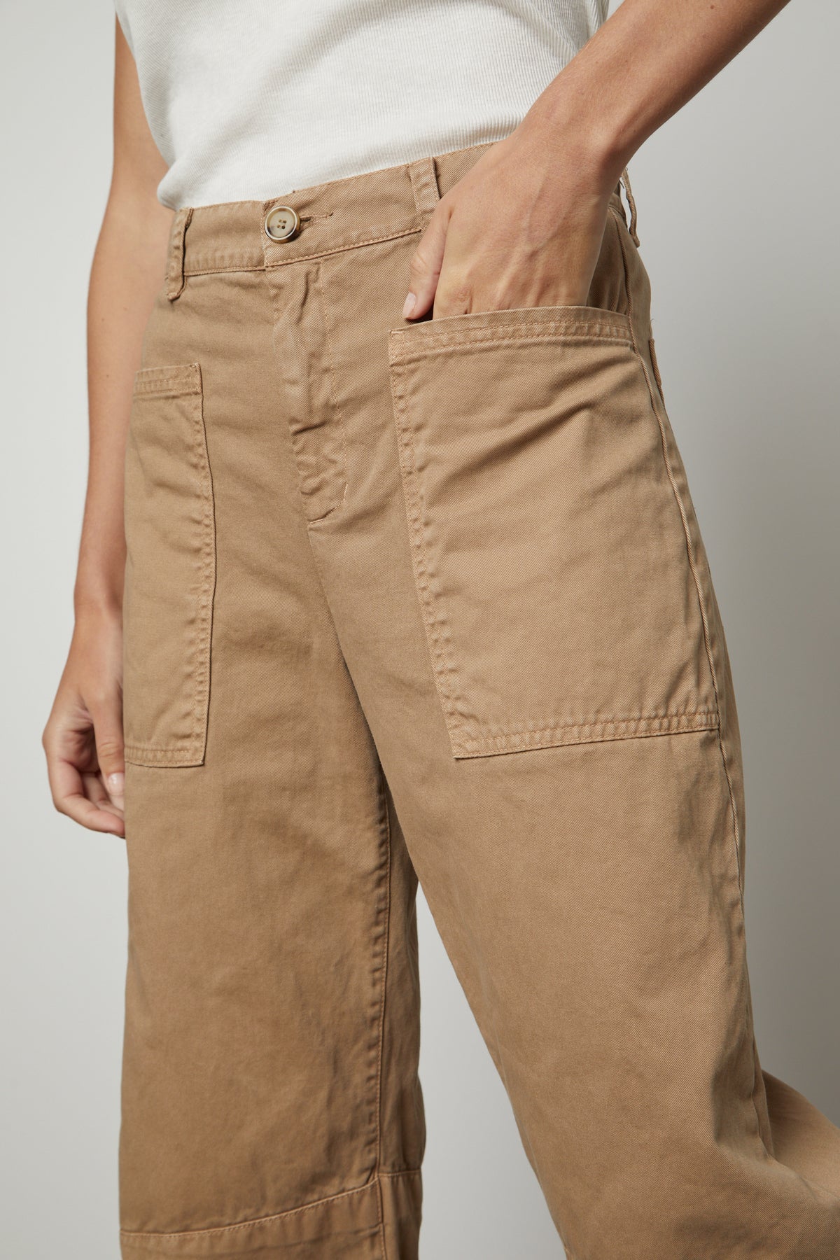 A woman wearing a pair of BRYLIE SANDED TWILL UTILITY PANT from Velvet by Graham & Spencer in sturdy cotton twill with utilitarian-inspired patch pockets.-36118556016833