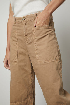 A woman wearing a pair of BRYLIE SANDED TWILL UTILITY PANT from Velvet by Graham & Spencer in sturdy cotton twill with utilitarian-inspired patch pockets.