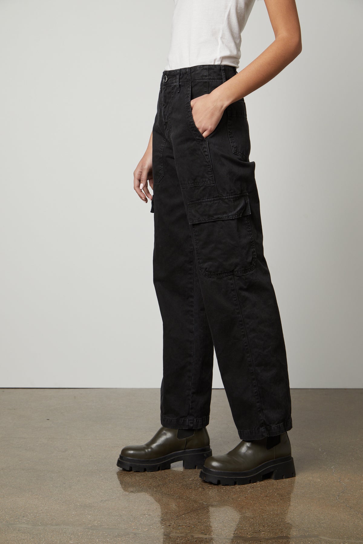 A woman wearing Velvet by Graham & Spencer MAKAYLA SANDED TWILL CARGO PANTS with pockets for added functionality and a white t-shirt.-26914867773633