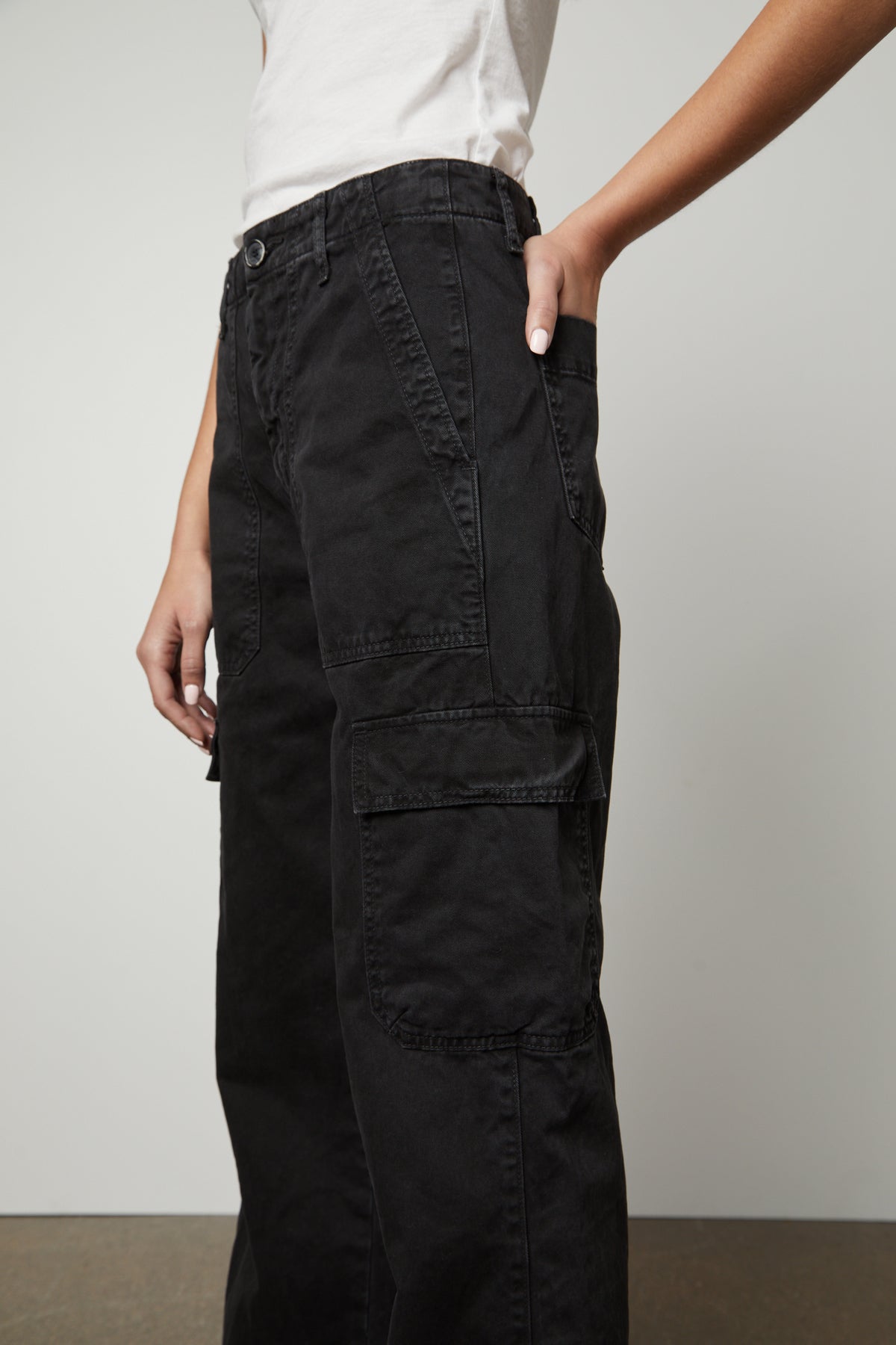 A woman wearing Velvet by Graham & Spencer's MAKAYLA SANDED TWILL CARGO PANT with slash and patch pockets.-26914867839169