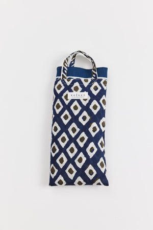 A SARONG WRAP with a blue and white geometric pattern and the word 